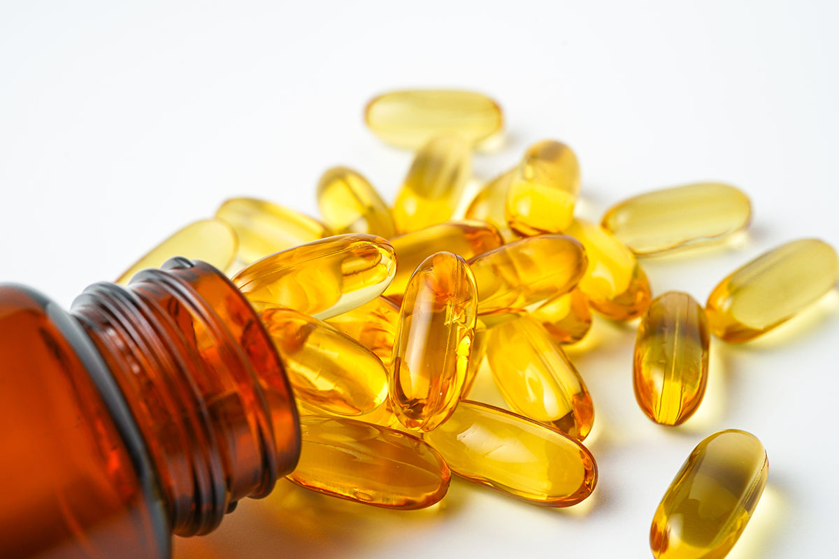 An image of a bottle of gel capsules spilling out