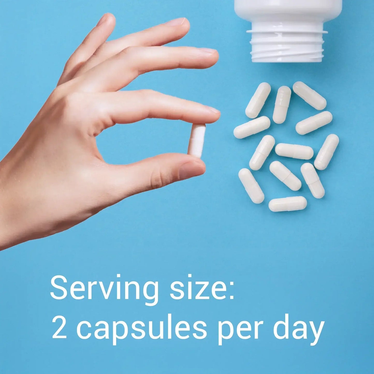 Hand holding a capsule with text about serving size on a blue background