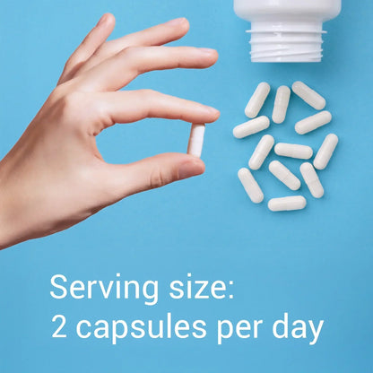Hand holding a capsule with text about serving size on a blue background