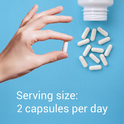 Hand holding a capsule with text about serving size on a blue background