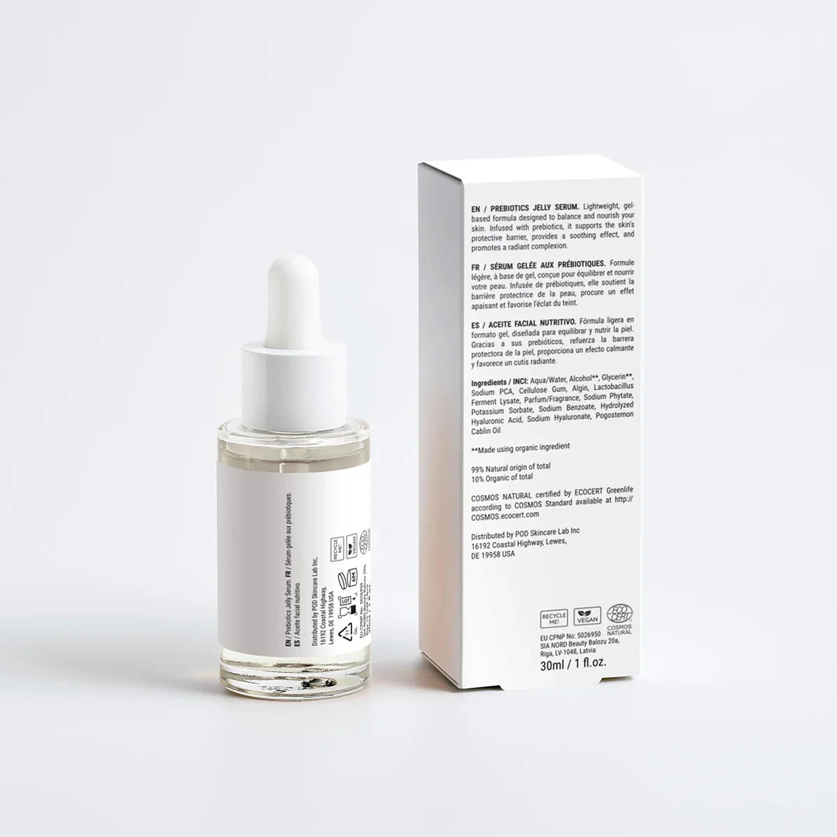 Skincare serum bottle with dropper and its packaging on a white background