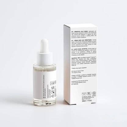 Skincare serum bottle with dropper and its packaging on a white background