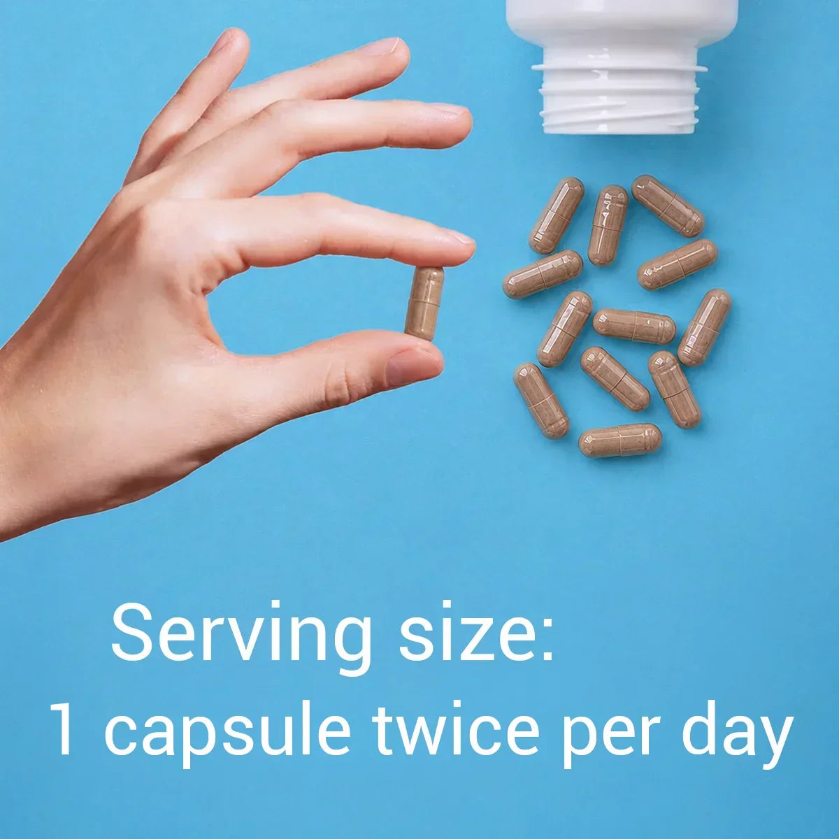 Hand holding a capsule with text about serving size on a blue background