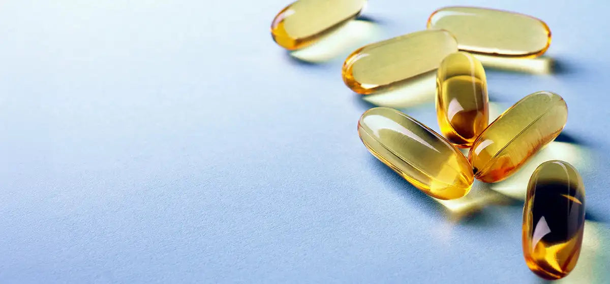 Yellow capsules on a light blue background
